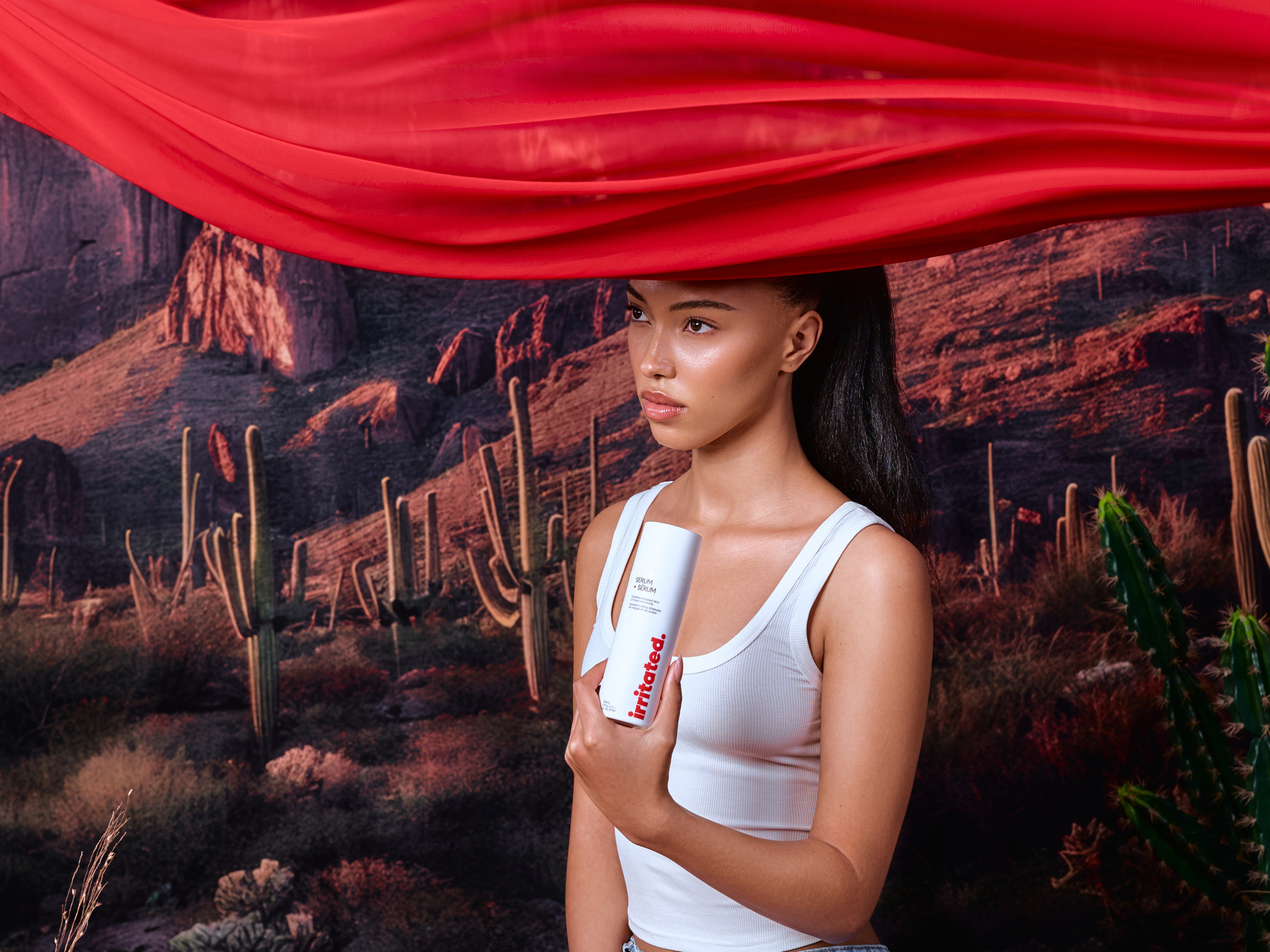 Ella MacCuish holding Irritated face and body serum in desert fragrance free sensitive skin