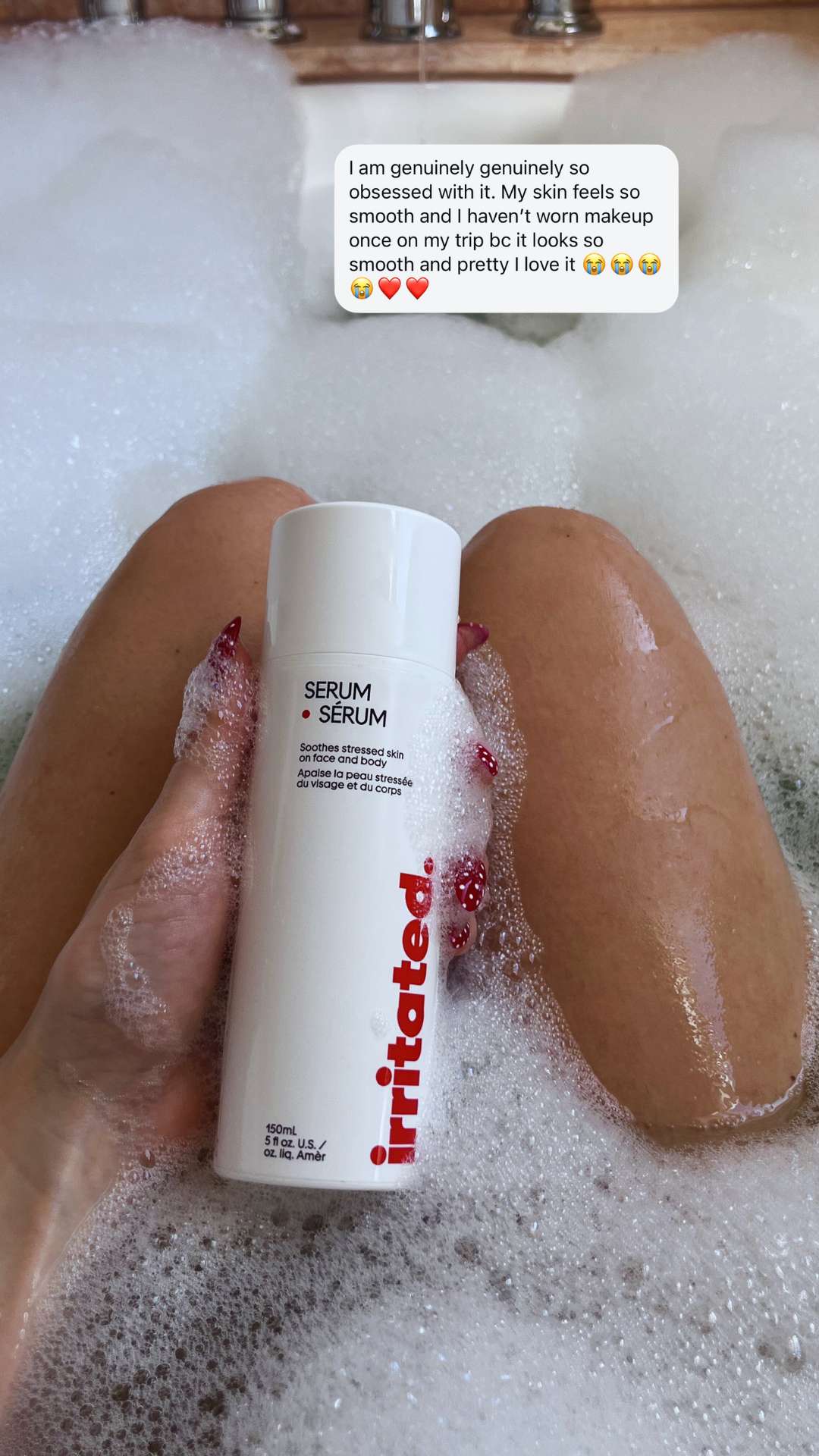 person in bath holding Irritated 150ml face and body serum for dry sensitive skin