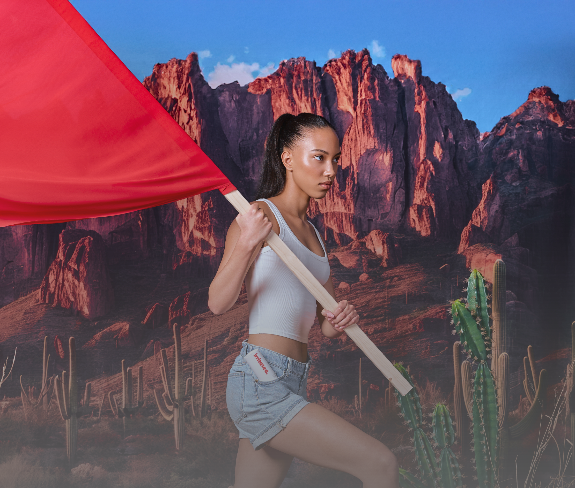 Ella MacCuish carrying red flag in desert with Irritated serum in pocket fragrance free sensitive skin